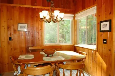 a dining room with a table and chairs and a chandelier at 30A Dunnings Retreat in Wawona