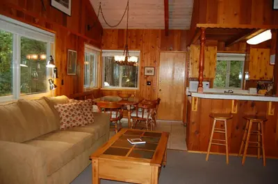 a living room with a couch and a table at 30A Dunnings Retreat in Wawona
