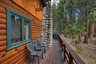 a row of chairs sitting on a porch of a house at 73 Walk-A-Bout in Wawona