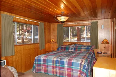 a bedroom with a bed in a wooden cabin at 6 Squirrels Nest in Wawona