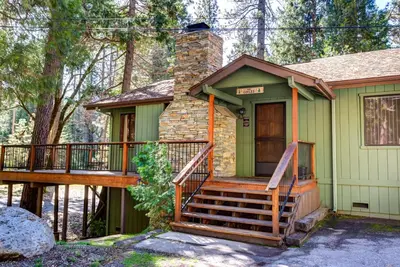a small house with a porch and a deck at 40 Coyles Cabin in Wawona