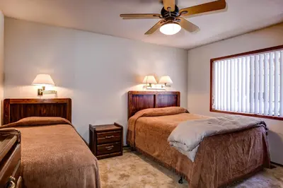 a bedroom with two beds and a ceiling fan at 40 Coyles Cabin in Wawona