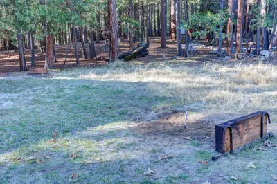 a wooden box in the middle of a field with trees at 81 Ashbaugh Meadow in North Wawona