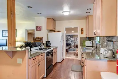 a kitchen with wooden cabinets and a white refrigerator at 81 Ashbaugh Meadow in North Wawona