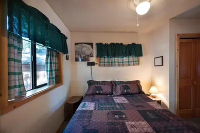 a bedroom with a bed and a window at 24 Wawona Cabin in Wawona