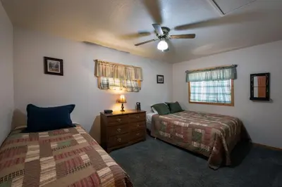 a bedroom with two beds and a ceiling fan at 24 Wawona Cabin in Wawona