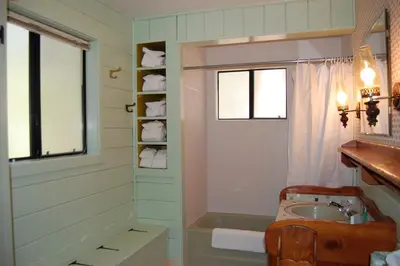 a bathroom with a sink and a tub and a window at 9S Pine Cabin in South Wawona