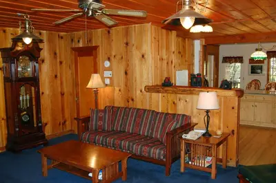 a living room with a couch and a table at 10N Black Oak Lodge in Wawona