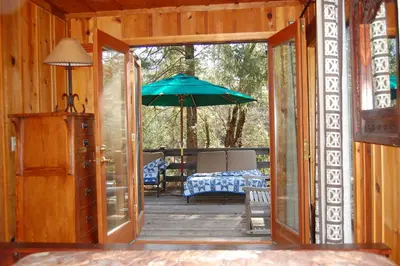an open door to a porch with an umbrella at 10N Black Oak Lodge in Wawona