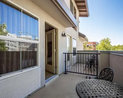 a patio with a table and chairs on a balcony at Hotel Med Park, an Ascend Collection Hotel in Sacramento