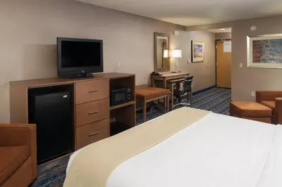 a hotel room with a bed and a flat screen tv at Holiday Inn Express Rocklin - Galleria Area by IHG in Rocklin