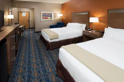a hotel room with two beds and a television at Holiday Inn Express Rocklin - Galleria Area by IHG in Rocklin