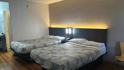 a hotel room with two beds in a room at Motel 6 Modesto, CA in Modesto