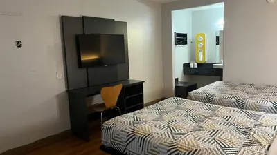 a hotel room with two beds and a television at Motel 6 Modesto, CA in Modesto
