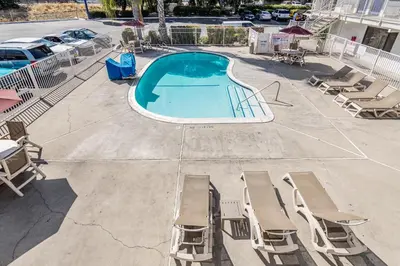 an overhead view of a swimming pool with chaise lounge chairs at Motel 6 Modesto, CA in Modesto