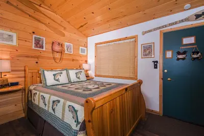 a bedroom with a bed in a wooden cabin at Fireside Lodge in South Lake Tahoe