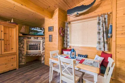 a dining room with a table and chairs and a fireplace at Fireside Lodge in South Lake Tahoe