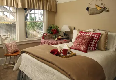 a bedroom with a large bed with a blanket at Cottage on Armstrong in Lodi