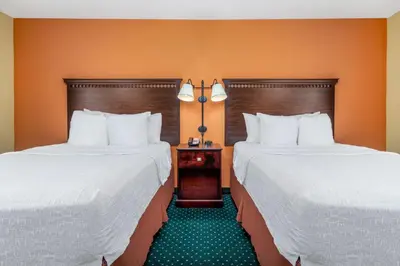 two beds sitting next to each other in a hotel room at Hampton Inn & Suites Sacramento-Elk Grove Laguna I-5 in Elk Grove