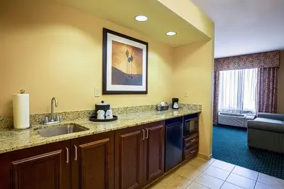 a kitchen with a sink and a living room at Hampton Inn & Suites Sacramento-Elk Grove Laguna I-5 in Elk Grove