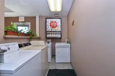 a laundry room with a stop sign on the wall at Americas Best Value Inn & Suites Madera in Madera