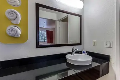 a bathroom with a sink and a mirror at Motel 6-Fresno, CA in Fresno