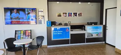 a restaurant with a cash register and a table and chairs at Motel 6-Santa Nella, CA - Los Banos in Santa Nella Village