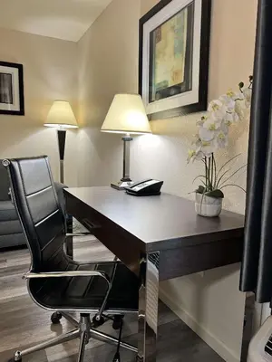 an office with a desk with a chair and a lamp at Best Western Americana in Dinuba