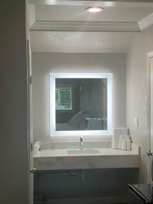 a bathroom with a sink and a mirror at Elmwood Motel in Auburn