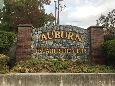 a sign for auburn sign on a brick building at Elmwood Motel in Auburn