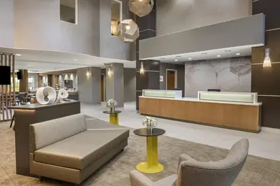 a lobby of a hotel with a couch and chairs at SpringHill Suites by Marriott Turlock in Turlock