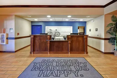 a lobby with a waiting area with a bike on the wall at Hampton Inn & Suites Folsom in Folsom