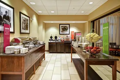 a restaurant with a counter with fruit on it at Hampton Inn & Suites Folsom in Folsom