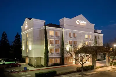 a large white building with a sign on it at Comfort Suites Clovis - Fresno in Clovis