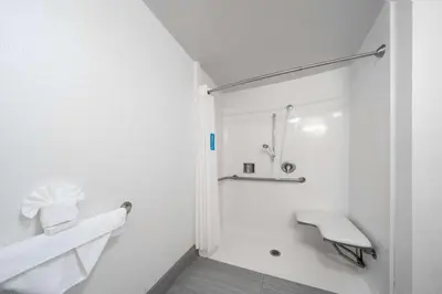 a white bathroom with a sink and a shower at Hampton Inn & Suites Modesto - Salida in Modesto