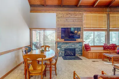 a dining room with a table and a fireplace at Indian Hills Hideaway in Ponderosa Fairway Estates