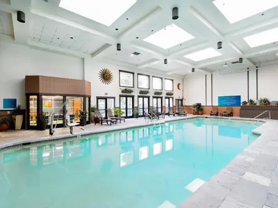a large swimming pool with blue water in a building at Tenaya at Yosemite in Fish Camp