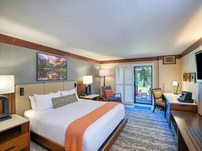 a hotel room with a bed and a desk at Tenaya at Yosemite in Fish Camp