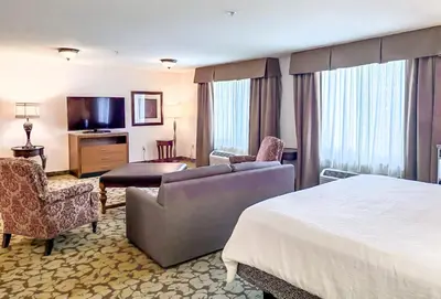 a hotel room with a bed and a television at Hilton Garden Inn Gilroy in Gilroy