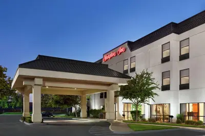 a hotel with a sign on the front of it at Hampton Inn Tracy in Tracy