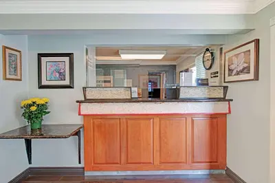 a kitchen with a counter and a mirror at Super 8 by Wyndham Sacramento/Florin Rd in Sacramento