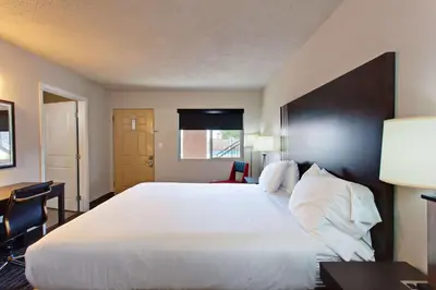 a hotel room with a large bed and a window at Days Inn by Wyndham Chowchilla Gateway to Yosemite in Chowchilla