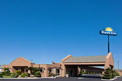 a days inn sign in front of a building at Days Inn by Wyndham Chowchilla Gateway to Yosemite in Chowchilla
