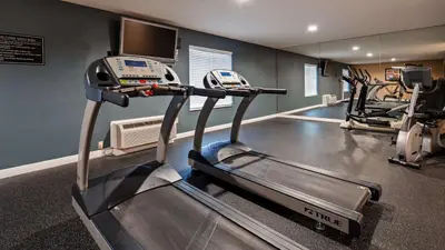 a gym with two tread machines and a treadmill at Best Western Plus Heritage Inn in Stockton