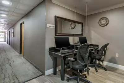 an office with a desk with two computers and chairs at Best Western Plus Vineyard Inn in Livermore