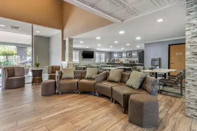 a living room with a couch and chairs and a table at Best Western Plus Vineyard Inn in Livermore