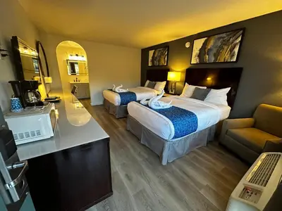 a hotel room with two beds and a couch at Sierra Inn in San Andreas