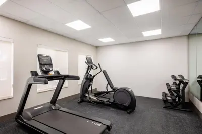 a gym with two exercise bikes and a treadmill at Holiday Inn Express Turlock by IHG in Turlock