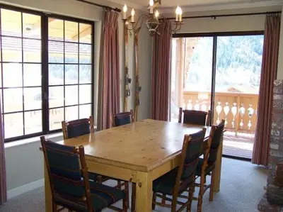 a dining room with a wooden table and chairs at Rr-interlaken 05 in June Lake