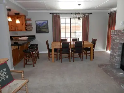 a dining room and living room with a table and chairs at Rr-interlaken 05 in June Lake